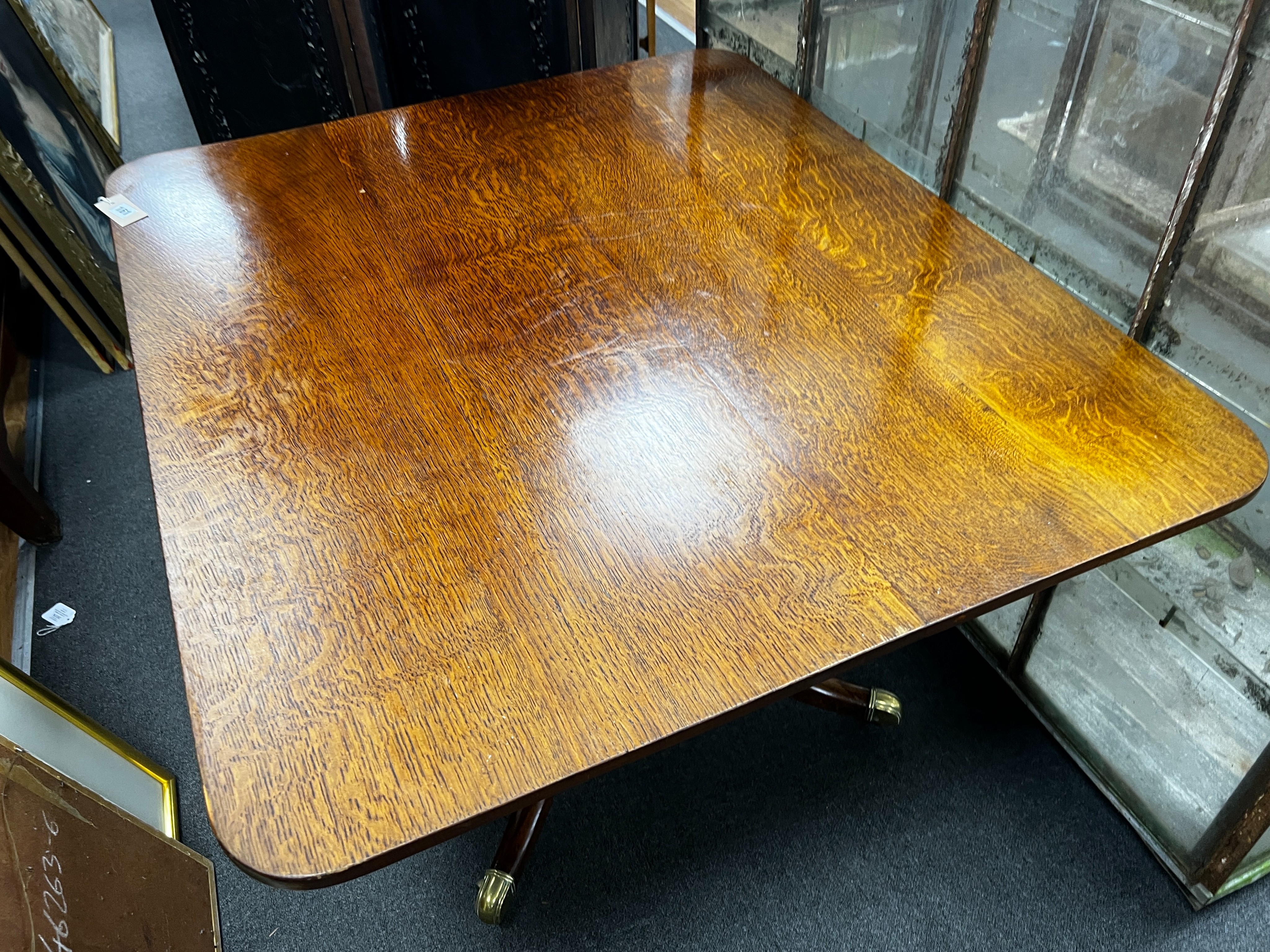 A Regency rectangular oak tilt top dining table, length 110cm, width 94cm, height 72cm